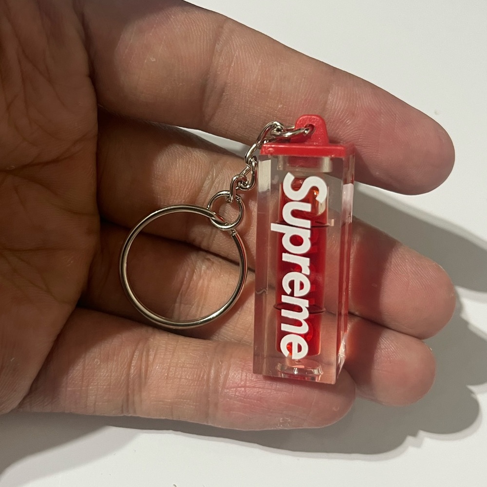 Supreme Clear Keychain with Red Logo and Cap